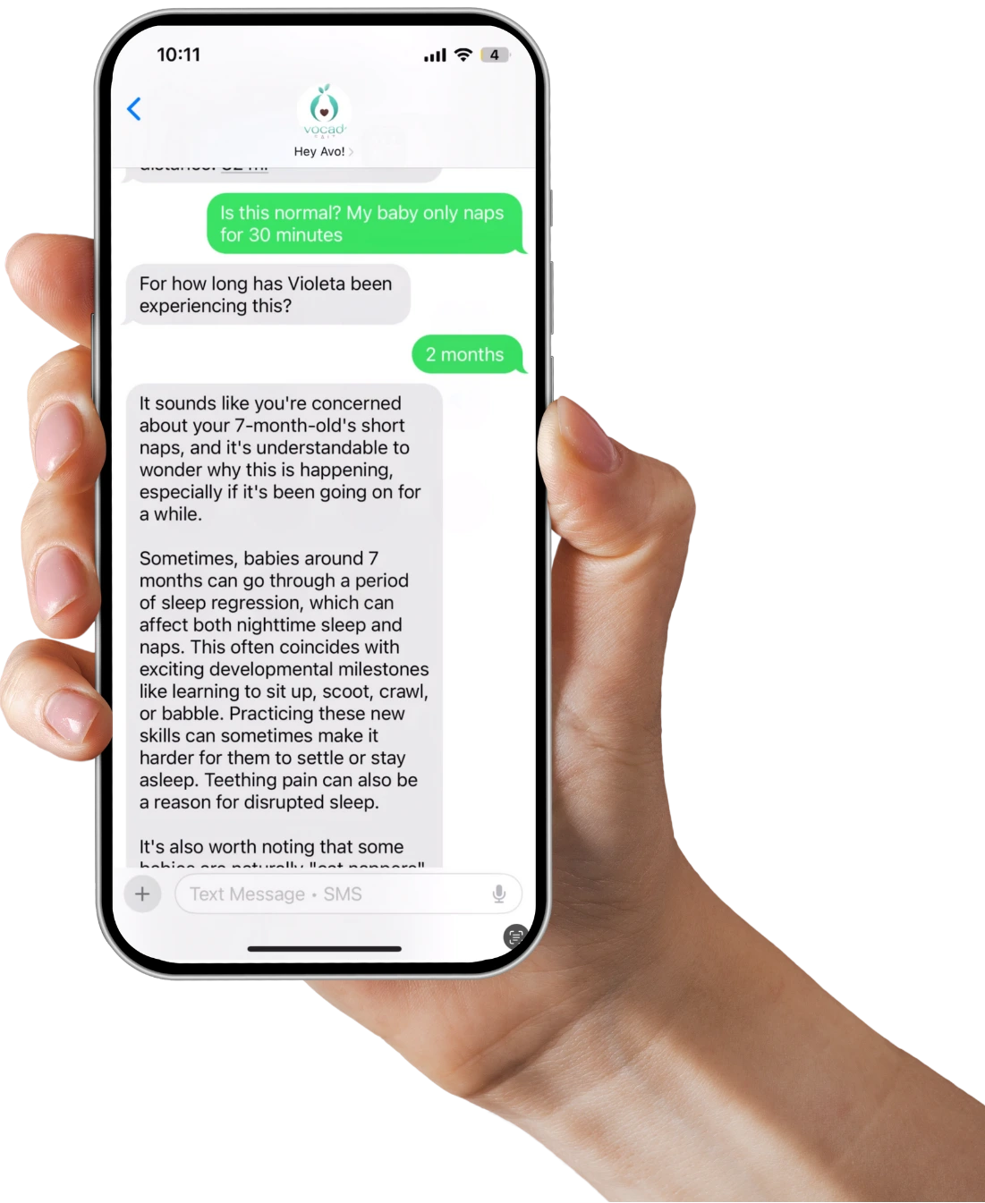 A hand holding a phone open to the Avo text line: a parent asks why her baby only naps for 30 minutes and gets a detailed answer back by SMS